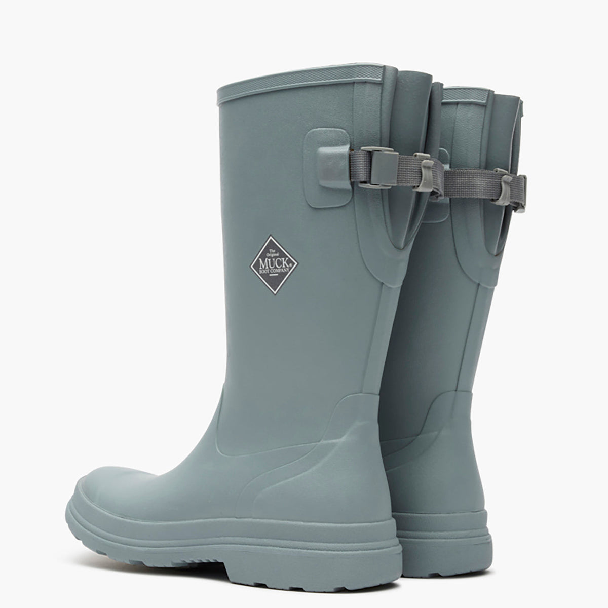 Pair of gray rubber boots with buckle details on a white background
